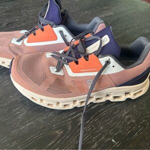 On Running Shoes with Vibrant Orange and Subtle Purple